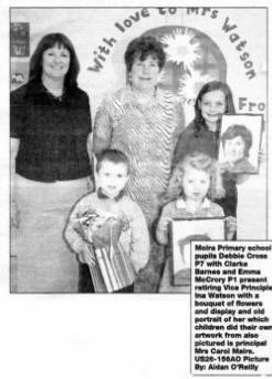 Moira Primary school pupils Debbie Cross P7 with Clarke Barnes and Emma McCrory P1 present retiring Vice Principle Ina Watson with a bouquet of flowers and display and old portrait of her which children did their own artwork from also pictured is principal Mrs Carol Mairs. US26-156AO Picture By: Aidan O'Reilly