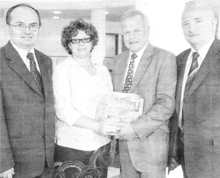 Reverend Eugen Groza and Director of Deborah Centre present Lisburn Mayor Trevor Lunn with gifts of appreciation during a visit to Lisburn City Council. Also included is Reverend Stanley Barnes. US32-116A0