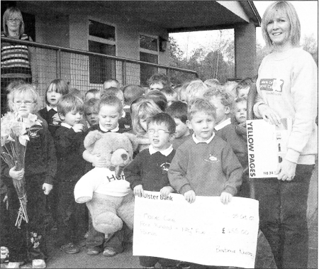 Amanda Scott, Marie Curie Cancer Cares Community Fundraising Co-ordinator, with staff and pupils from Barbour Primary School