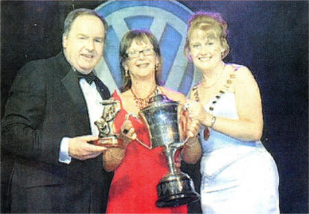 Anne McCleary, Chairperson of Fusion Theatre, is presented with the trophy by Fiona Sheerin ( President of AIMS) and Tom O'Connor Sales Manager of WDL Volkswagen (Ireland) the principal sponsors of AIMS. US2607-AIMS 1