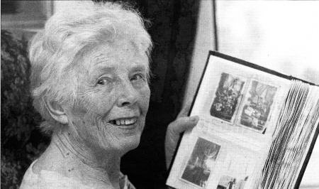 Marjory Wilson looks through old photos of herself and family at work in the Mill. US4407-521CO