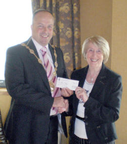 Mrs Gertie Reid, President of Magheragall WI presents a cheque for �800 to the then Mayor, Councillor James Tinsley for the Make a Wish charity. The money was raised at a concert organised by Magheragall W.I. to celebrate their 60th Anniversary.