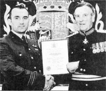 Flight Lieutenant Ian Campbell, who serves with the Volunteer Gliding Squadron, receives his Award from Colonel William Hall, Her Majesty's Lord Lieutenant for the County of Down.