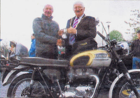 Deputy Mayor Ronnie Crawford presents the cup to Robert Watson