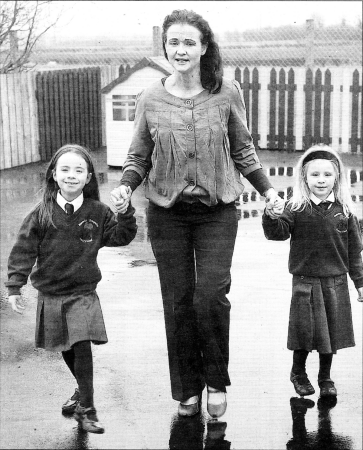 " Rowandale Integrated Primary School pupils Calla Nic Aoidh and Anna Nic Aoidh who both suffered from Meningitis pictured with their mother and school principal Mrs Frances Hughes raising awareness of Meningitis by taking part in a Toddle Woddle in the School. US1408-113A0 Picture By Aidan O'Reilly