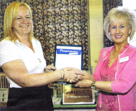 WeightWatchers' Bernie Walsh presents Jennifer Cobbett with an award for losing 100Ibs / 7st 2lbs through the WeightWatcher plan. US2108-403PM