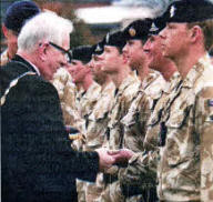 Councillor Allen Ewart, Mayor of Lisburn giving the Operational Service Medal (OSM) for Afghanistan to Gunner Mogg, a reservist attatched to 49 Battery, 40 Regt the Royal Regiment of Artillery (the Lowland Gunners)