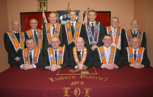 L to R: (seated) Bro Robert Orr (District Treasurer), Bro Tom Kerr (Deputy District Master), Bro Fred Willoughby (Worshipful District Master), Bro Jonathan Beattie (District Secretary) and Bro William Braithwaite (Assistant Secretary).  (back row) Bro Henry Smyth (Assistant Treasurer), Bro Jim Drake (First Committee), Bro Jim Ferguson (District Lay Chaplain), Bro Derek Cameron (Second Committee), Bro Tom Harrison (Third Committee), Bro Norman Hall (Inside Tyler) and Bro Jim Halliday (District Lecturer 2).