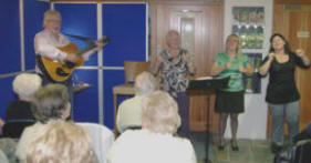 Pat Williams, Catherine O’Reilly and Lillian McFarlane perform the actions while Noel McMaster of Bakerloo Junction sings ‘The fields of Athenry’.