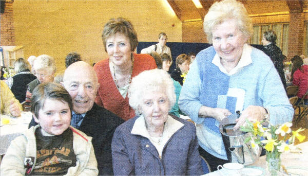 Joyce Moran (Chairperson of Lisburn Cancer Research Committee) serves up a 'Big Breakfast' last Friday for the charity morning to Carol Campbell and her parents Thomas and Jeanette Weekes and grandson Samuel.  