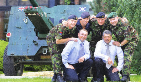 Sergeant Muir Philip and W02 Sergeant Major Gary Griffiths (front) with Major Sam Pinkney, Lance Corporal David Flounders, the Troop Commander and Sergeant Will Bennett, members of 40 Regiment Royal Artillery The Lowland Gunners', getting ready to welcome Lisburn soldiers currently serving in Afghanistan back to Lisburn. US3209-502CD