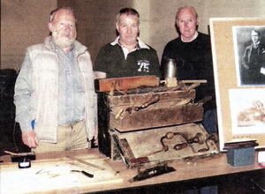 Secretary of the Association, Jim Halliday, Past Chairman, Bobby Harron and Chairman of the Larchfield Community Development Association, Irvine McKnight, standing beside memorabilia for the Titanic Festival exhibition.