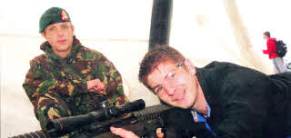 James Currie, 17 from South Eastern Regional College in Lisburn practices target shooting under the supervision of Corporal Leek of the Royal Military Police at the Army Careers Exhibition.