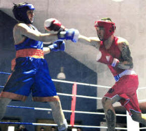 Lance Corporal Niki Gittus (red) Vs Joe Hillerby Sandy Row Boxing (blue). Lance Corporal Gittus recently won his bout at a Charity Boxing event for Help The Heroes. Image by Mike 0'Neill.