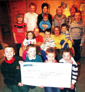 The Fletcher Family receive a cheque of £4500 from friends which they raised 'during a Family Fun day at Maze Presbyterian Church on 2nd January. US0210-108A0