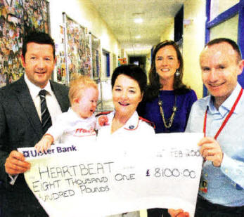 Gerard McAdorey, MD of GM Marketing with wife Maria and son Theo present 
	Alison Kearney and Dr Andrew Sands from the Clark Clinic in the RVH with 
	cheque for £8,100 for Heartbeat Nl.