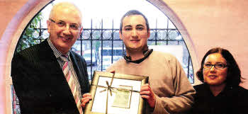 Stephen Gillespie , a Stepping Stones trainee, presents Employment and Learning Minister, Danny Kennedy with a picture made in the Organisation's framing service- Also in the picture is Paula Jennings. Stepping Stones, Chief Officer.