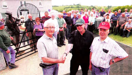 Bill Forsythe and Eric Jess of the Harry Ferguson Memorial Committee welcome Peter Love of Tractor Magazine and tourists to the Harry Ferguson Memorial Garden- US3010-105A0