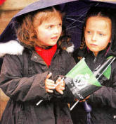 Taking shelter under an umbrella as the Royal Irish Regiment parades through Lisburn. US2111-566cd