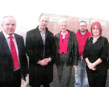 Councillor James Tinsley, Rob Lewis Developer, Tracy Crothers, Sam and Helen Reddick of Maghaberry Community Association with Councillor Paul Givan in front of the site where two houses will be built US1111-114A0 Picture By: Aidan O'Reilly