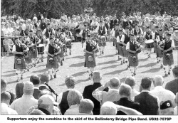 Supporters enjoy the sunshine to the skirl of the Ballinderry Bridge Pipe Band.